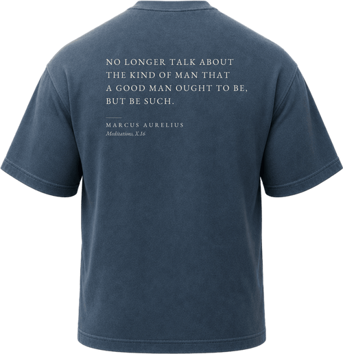 Pigment Midnight Navy
Back view of a faded, dark navy heavyweight cotton t-shirt cut in an intentionally oversized, boxy shape. The garment features architecturally balanced typography printed in Warm Parchment ink. The printed text reads: "NO LONGER TALK ABOUT THE KIND OF MAN THAT A GOOD MAN OUGHT TO BE, BUT BE SUCH." with the attribution "MARCUS AURELIUS" and "Meditations, X.16" directly underneath in a classic serif font.