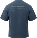 Pigment Midnight Navy
Back view of a faded, dark navy heavyweight cotton t-shirt cut in an intentionally oversized, boxy shape. The garment features architecturally balanced typography printed in Warm Parchment ink. The printed text reads: "THE UNEXAMINED LIFE IS NOT WORTH LIVING." with the attribution "SOCRATES" and "Plato, Apology" directly underneath in a classic serif font.