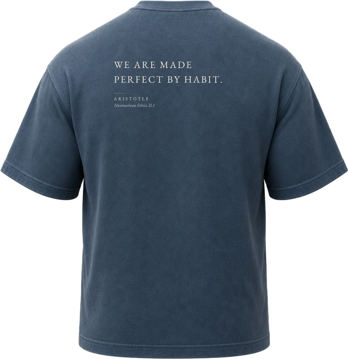 Pigment Midnight Navy
Back view of a faded, dark navy heavyweight cotton t-shirt cut in an intentionally oversized, boxy shape. The garment features architecturally balanced typography printed in Warm Parchment ink. The printed text reads: "WE ARE MADE PERFECT BY HABIT." with the attribution "ARISTOTLE" and "Nicomachean Ethics, II.1" directly underneath in a classic serif font.